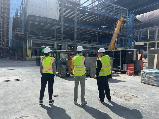 three men at a construction site