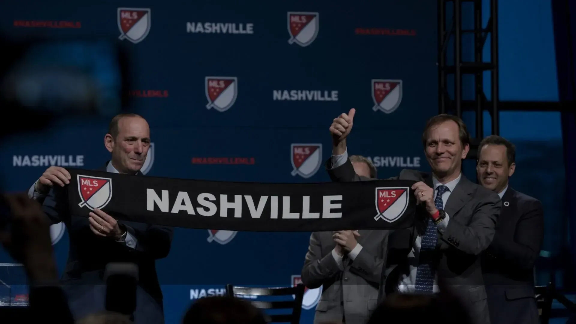 men holding up a nashville banner